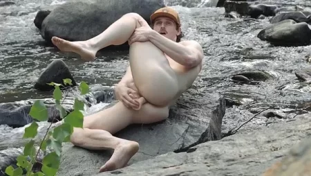 Tom The Cowboy uses a dildo by the river and then cums